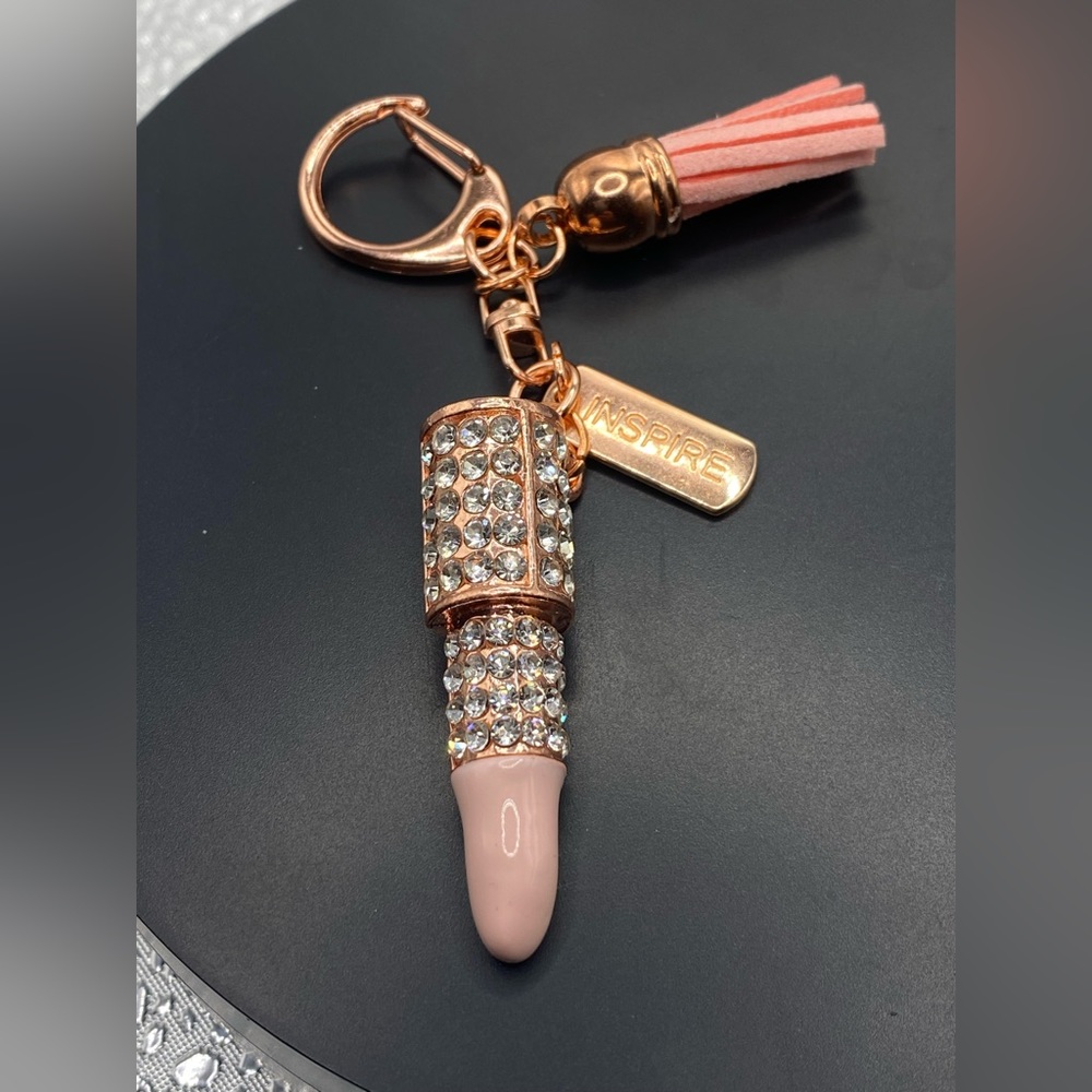 Light pink rose gold keychain with a tag that says inspire